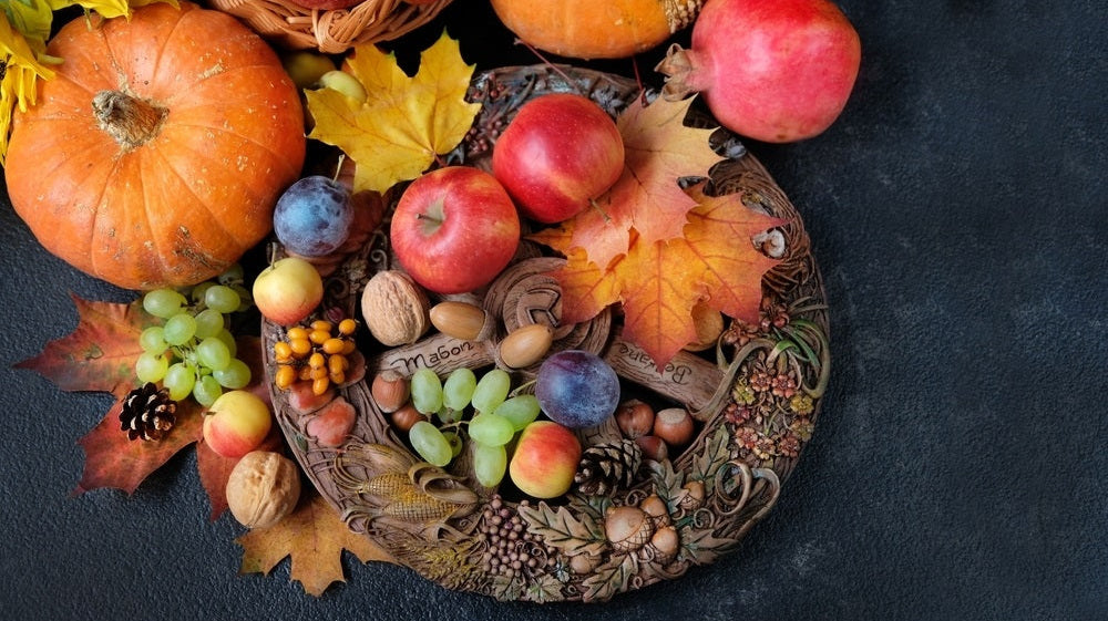 Harvest fruits and autumn leaves on altar