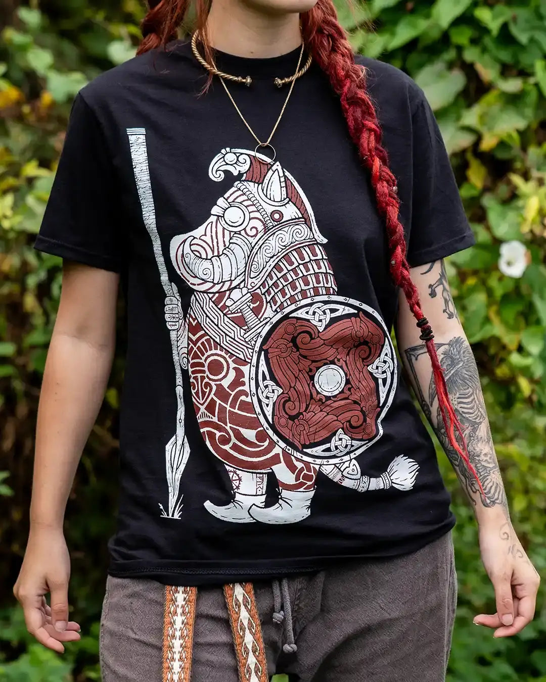 Viking warrior boar design on black t-shirt with Norse knotwork and shield, worn outdoors