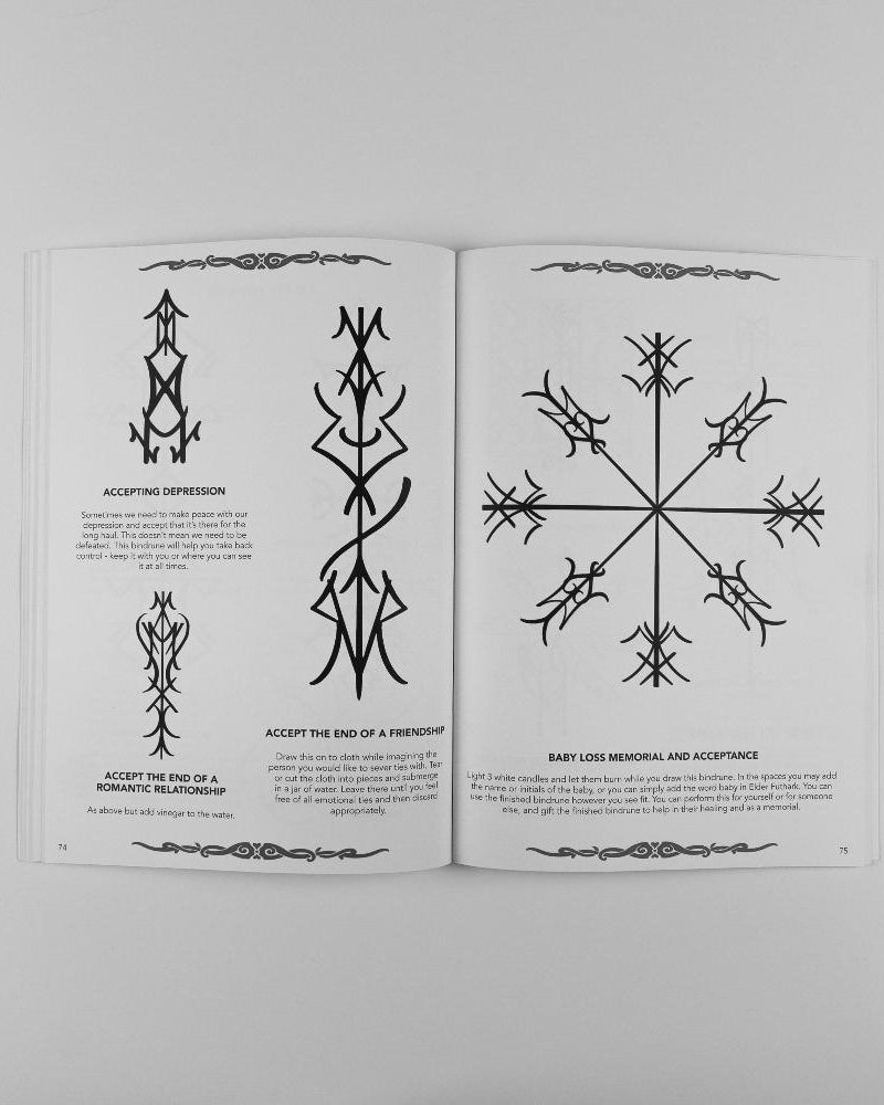 Norse-inspired tattoo designs and runes for emotional healing and acceptance in a Viking art book