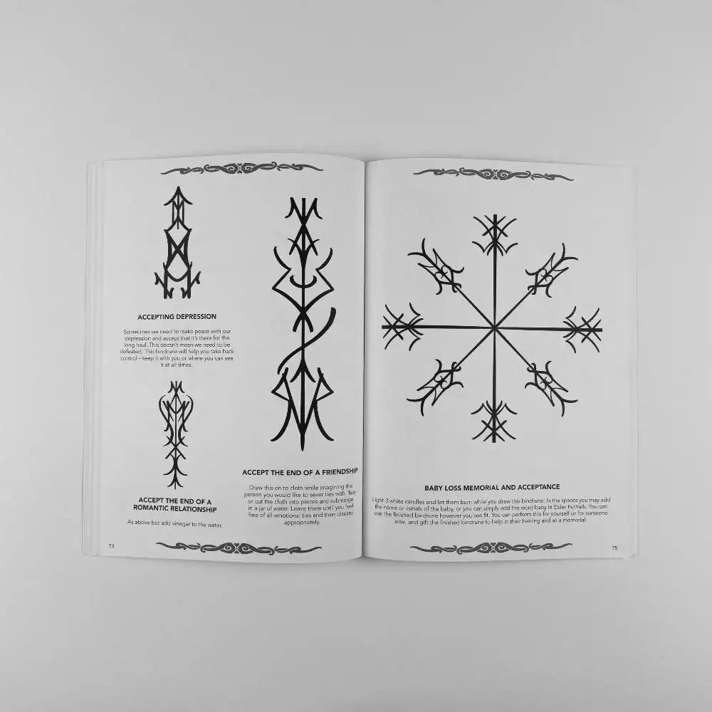 Norse-inspired tattoo designs and runes for emotional healing and acceptance in a Viking art book