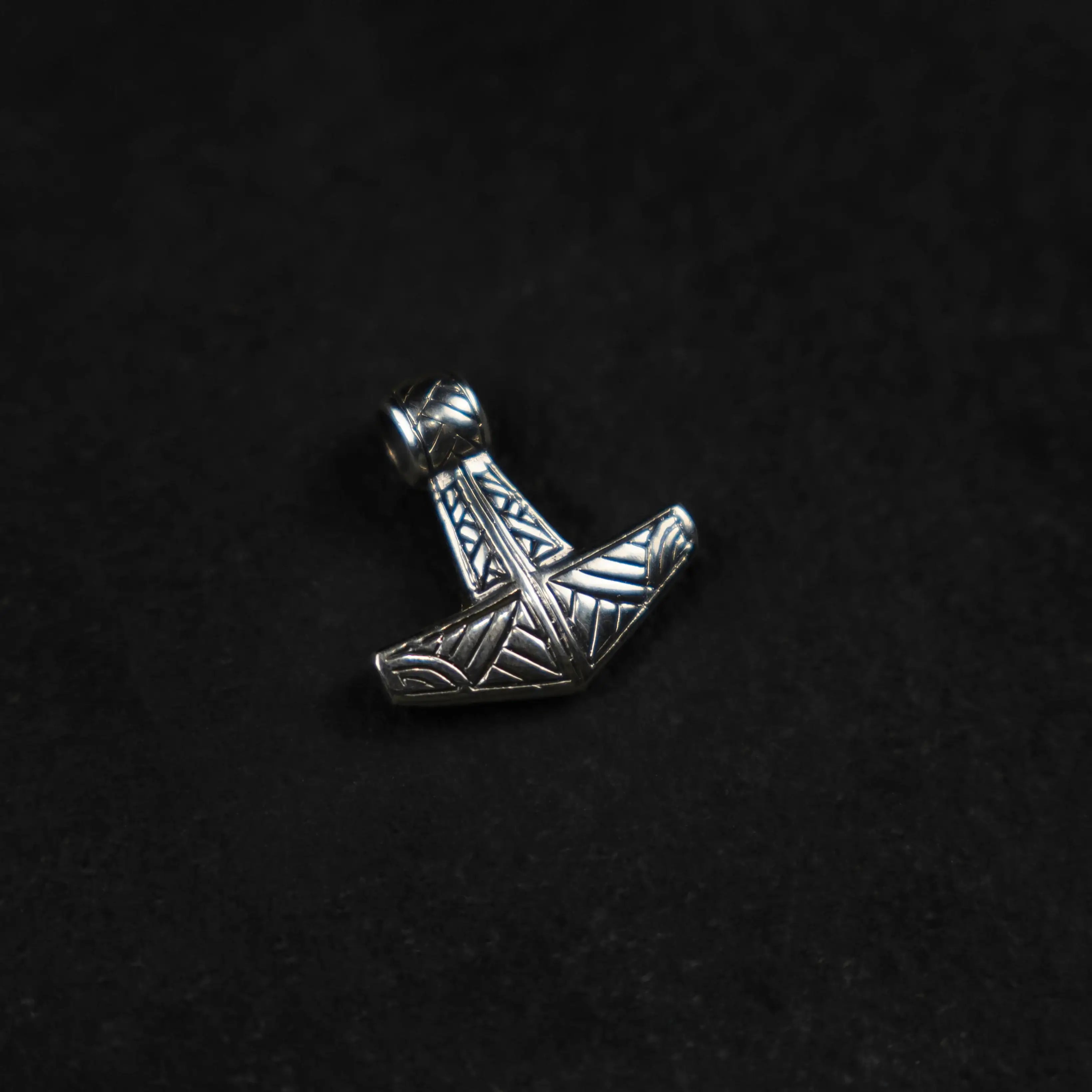 Silver Thor's hammer pendant with Norse knotwork, Viking jewelry on black background
