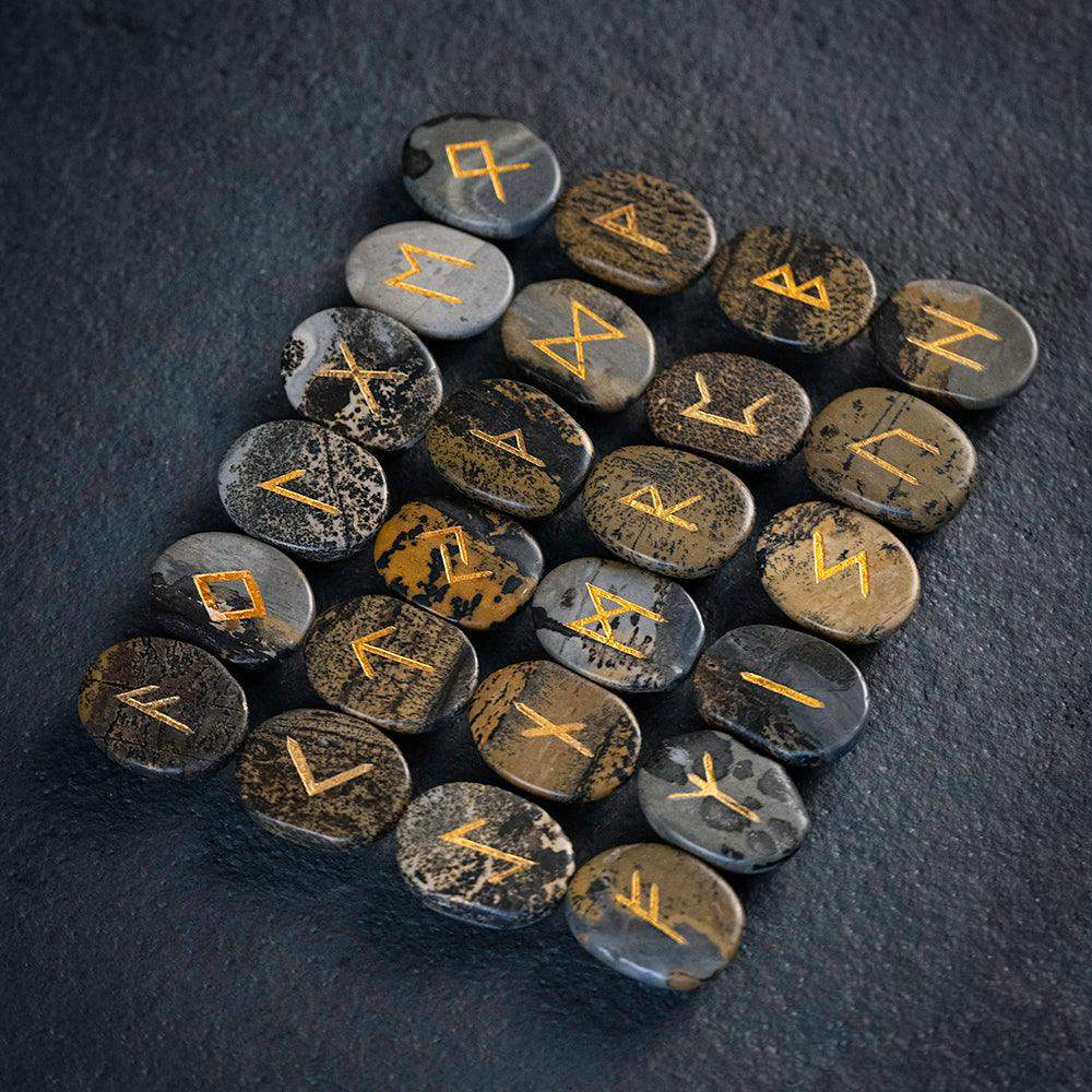 Norse runes engraved on stones with golden symbols, authentic Viking-inspired artifacts