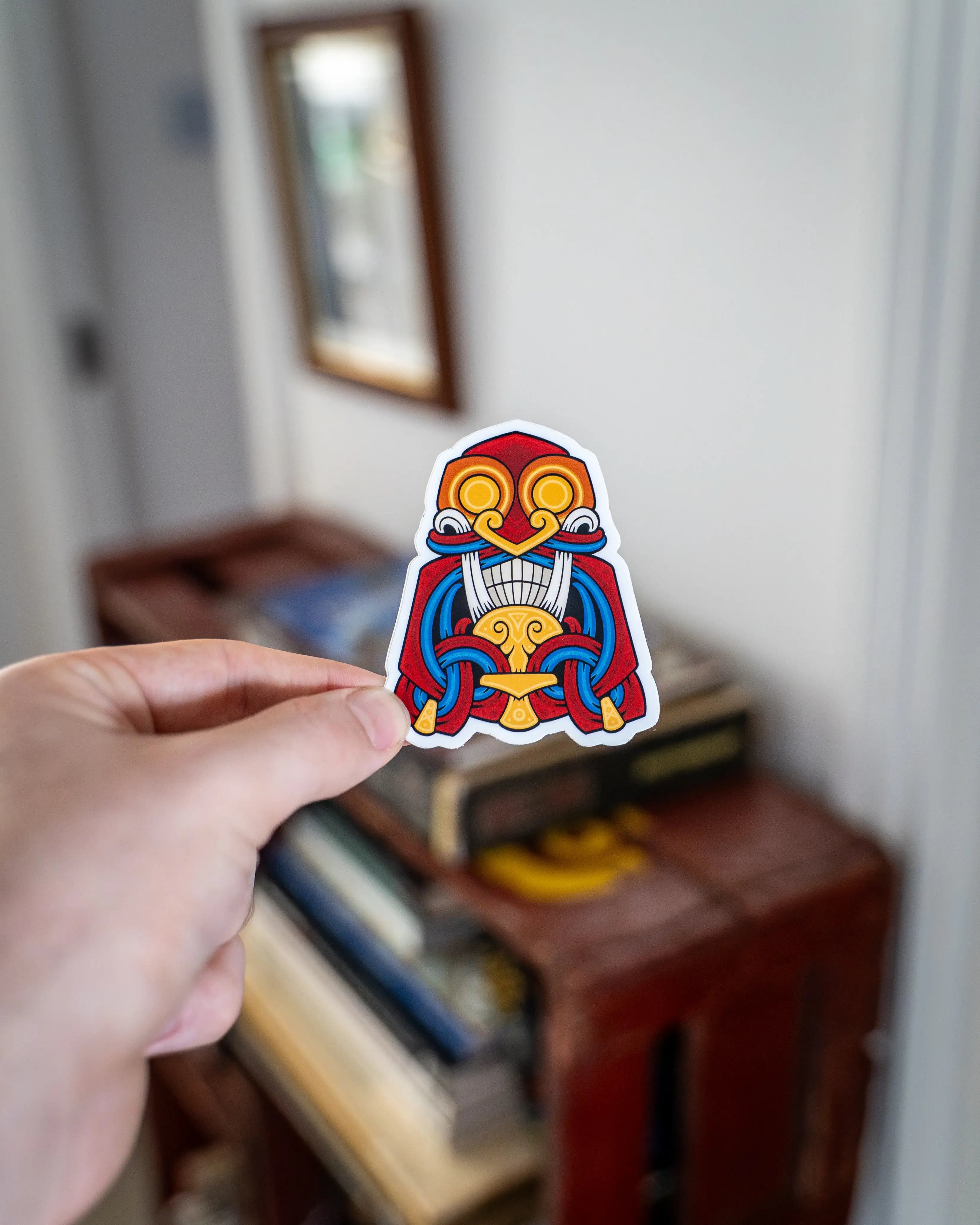 Viking-inspired sticker with bold Norse design, featuring red, blue, and gold colors.