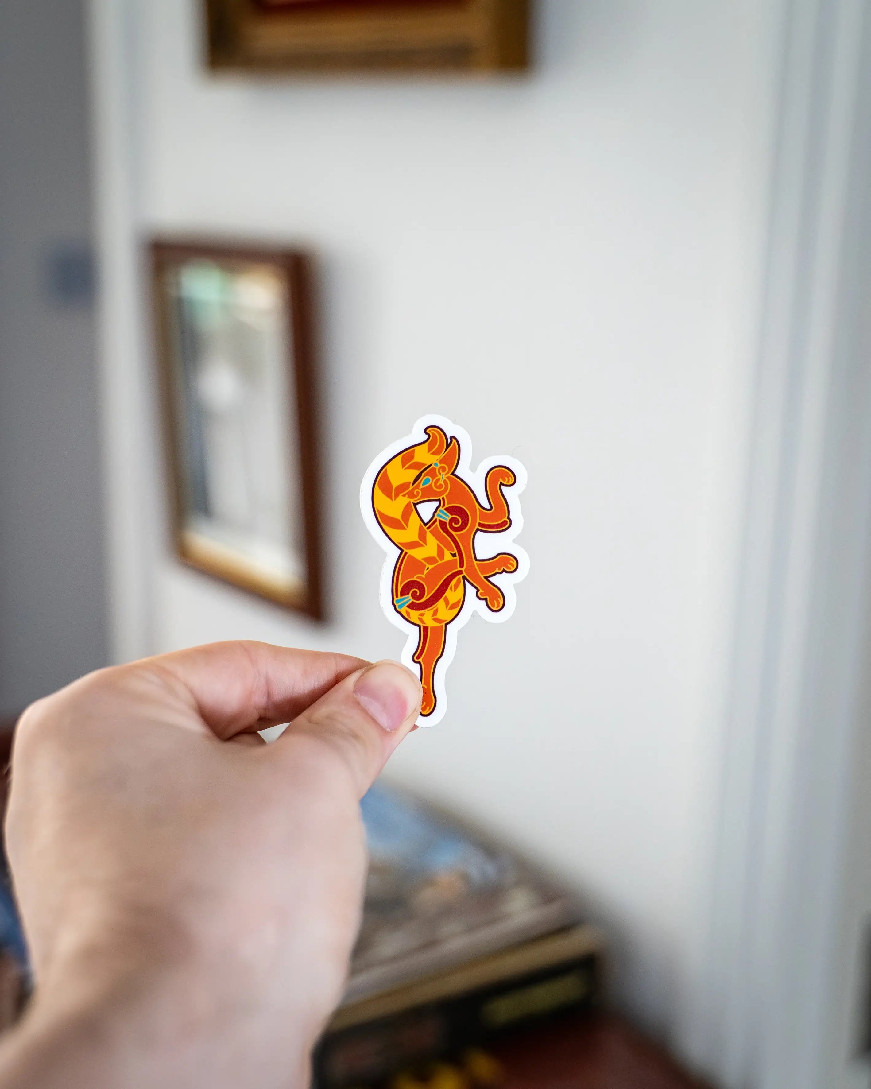 Viking dragon sticker with Norse art design, held in hand