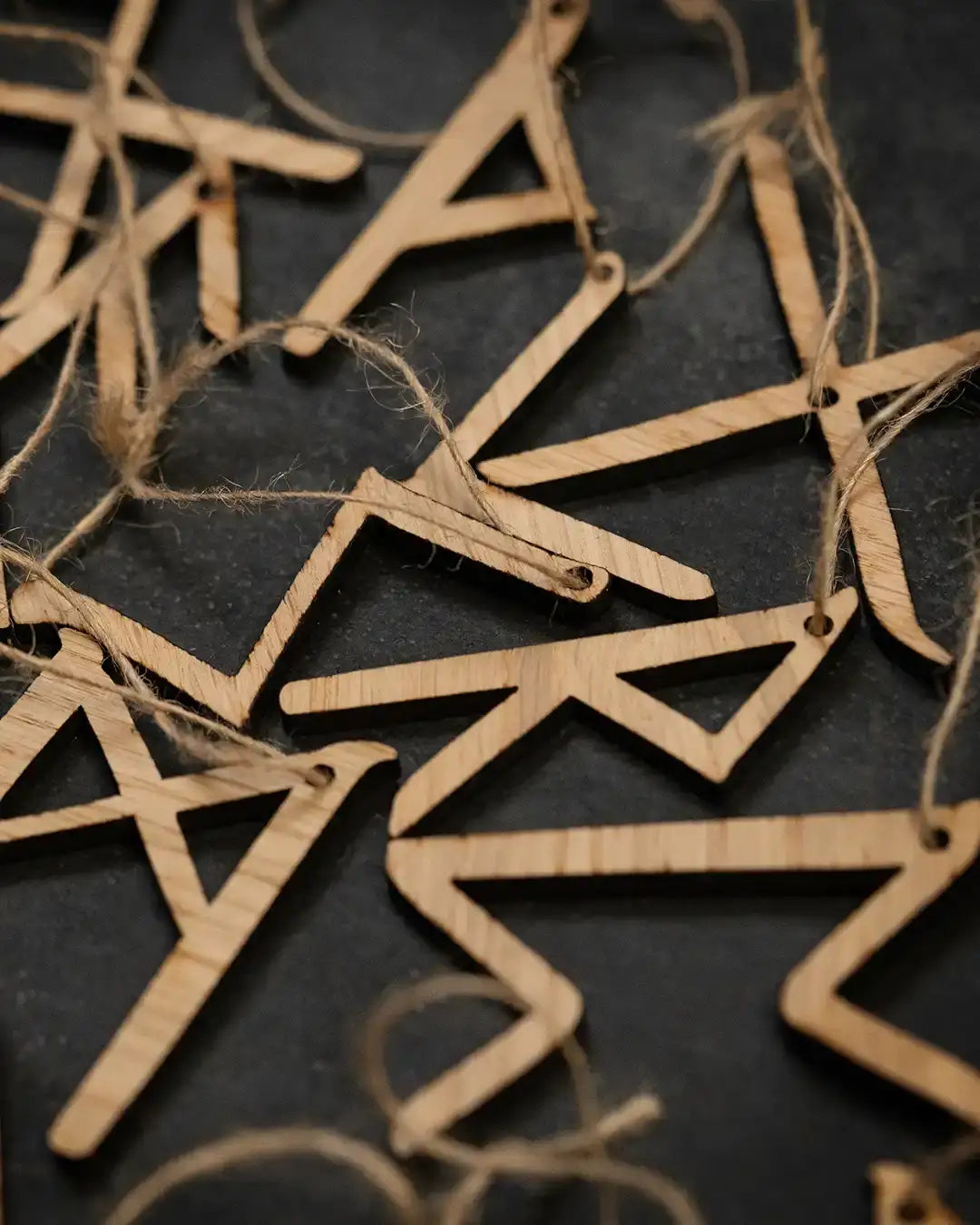 Wooden Norse rune ornaments with twine, inspired by Viking artifacts and runic symbols