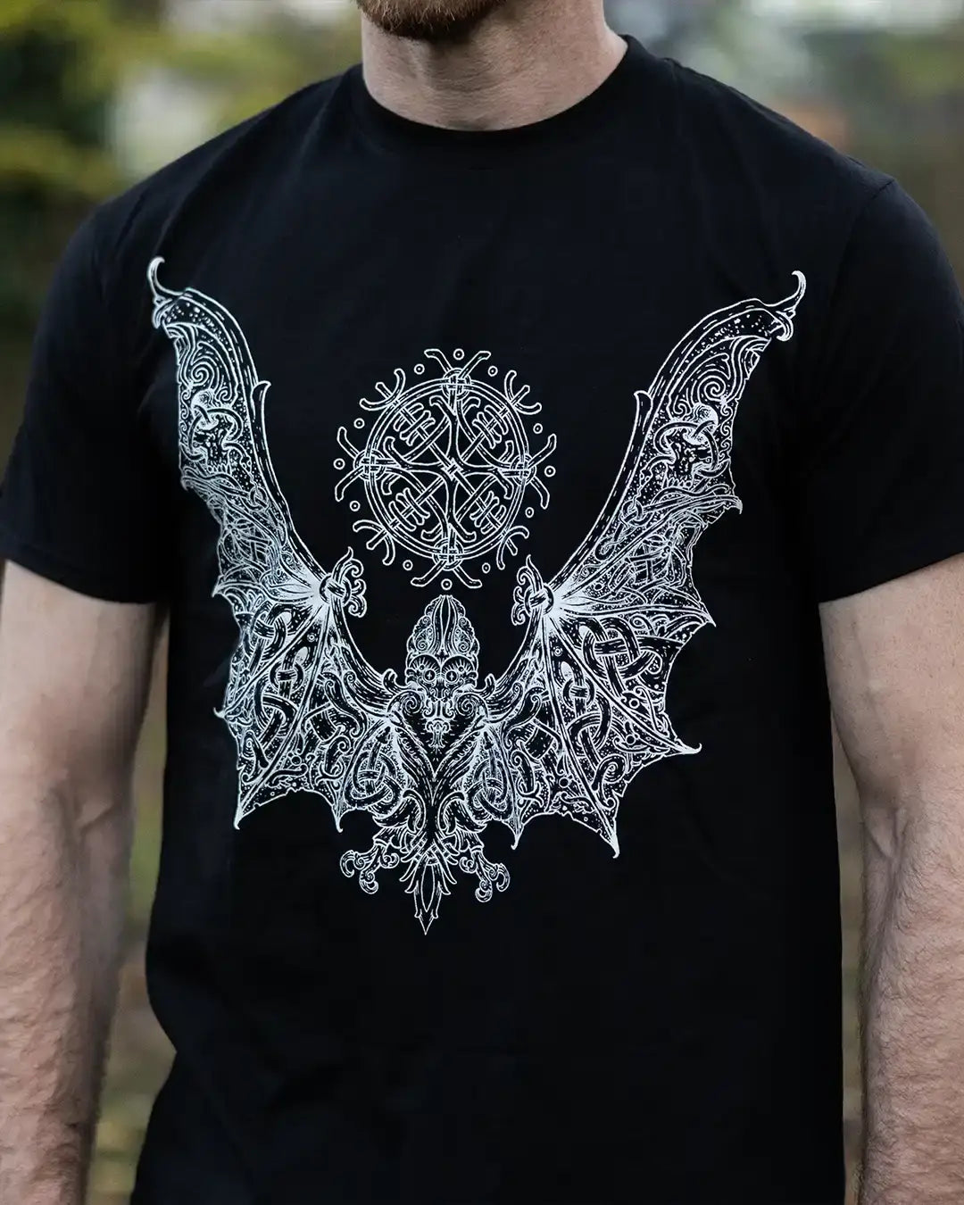 Black t-shirt with intricate Norse-inspired bat wing design and runic symbols
