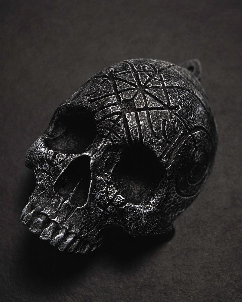 Dark skull pendant with Norse runes and Viking knotwork, textured black finish