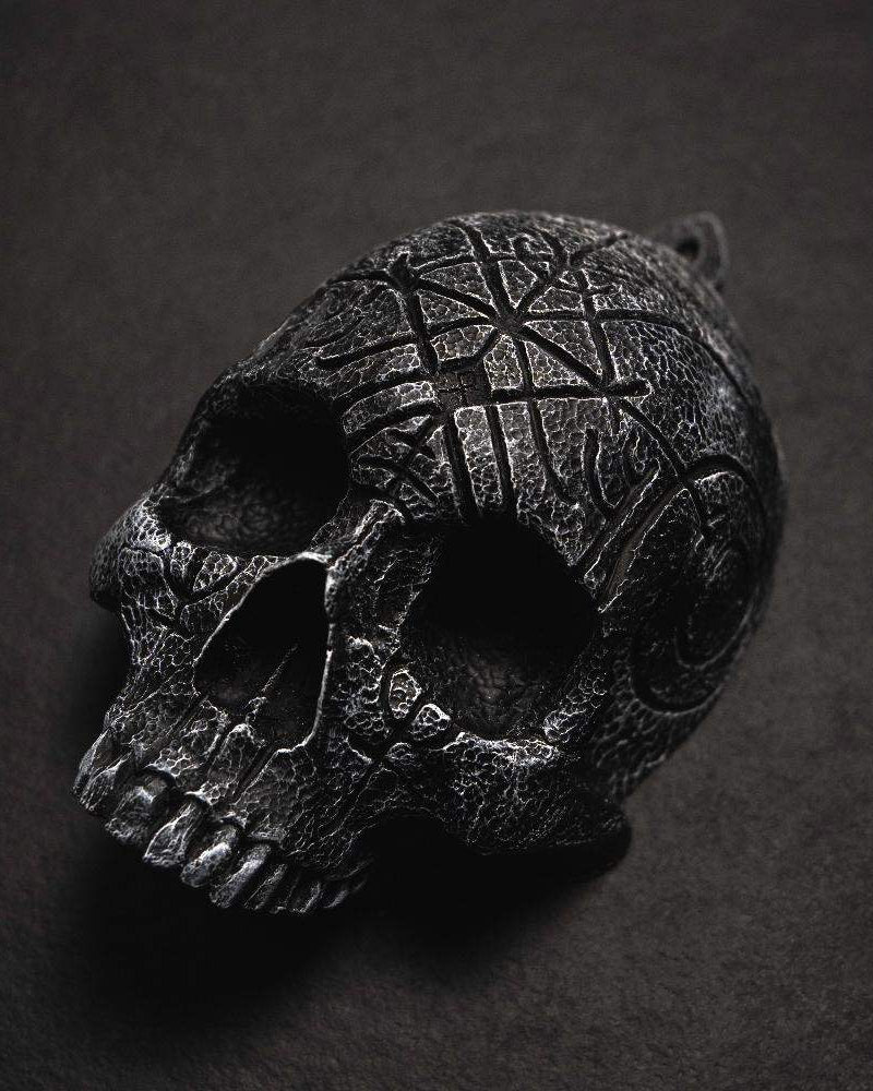 Dark skull pendant with Norse runes and Viking knotwork, textured black finish