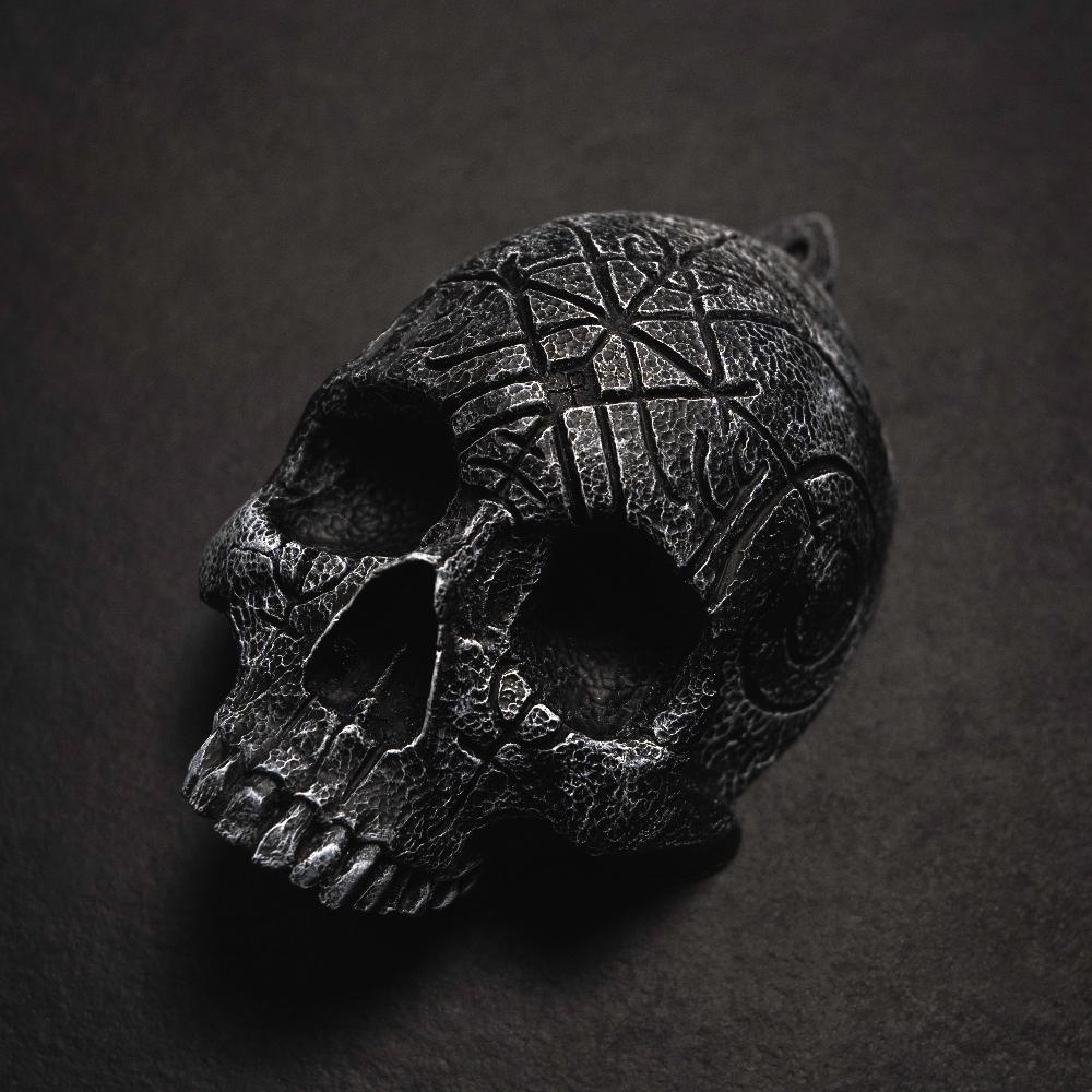 Dark skull pendant with Norse runes and Viking knotwork, textured black finish