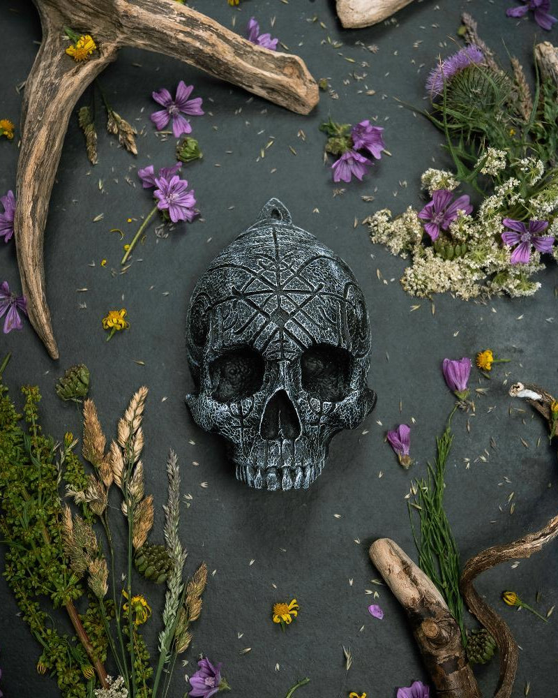 Carved Norse rune skull with antlers and wildflowers, Viking-inspired decor