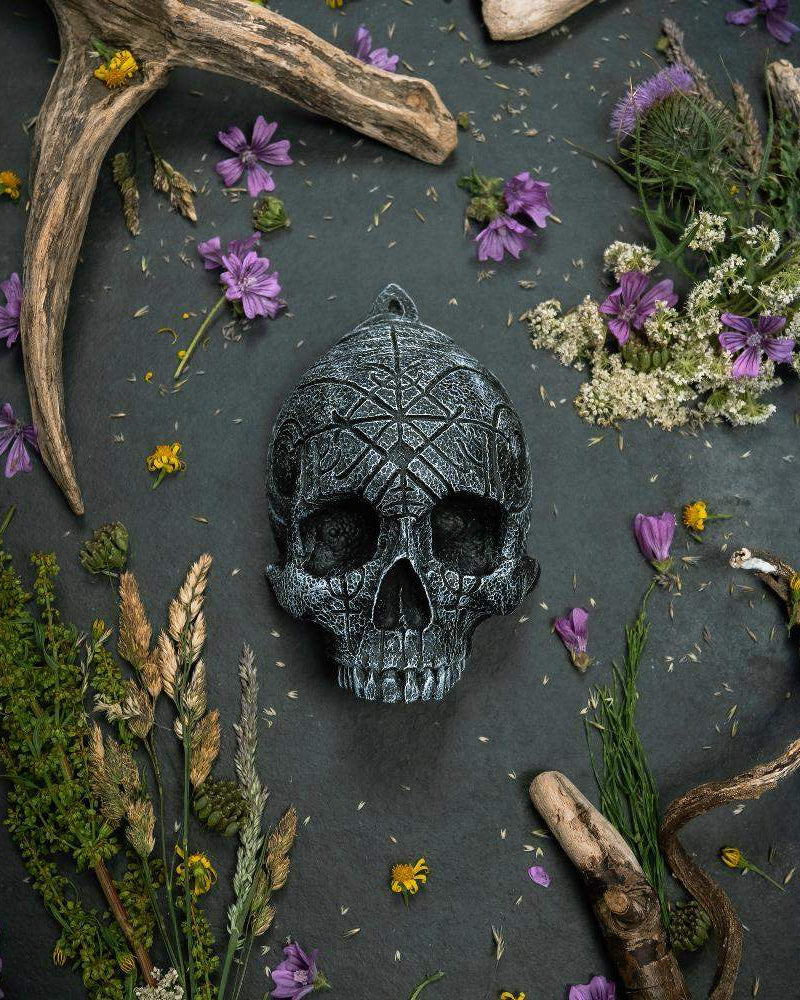 Carved Norse rune skull with antlers and wildflowers, Viking-inspired decor