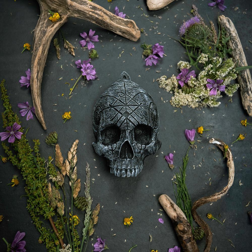 Carved Norse rune skull with antlers and wildflowers, Viking-inspired decor