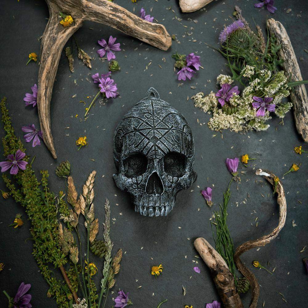 Carved Norse rune skull with antlers and wildflowers, Viking-inspired decor