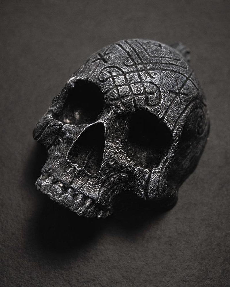Dark skull pendant with Norse knotwork and runes, Viking-inspired jewelry design