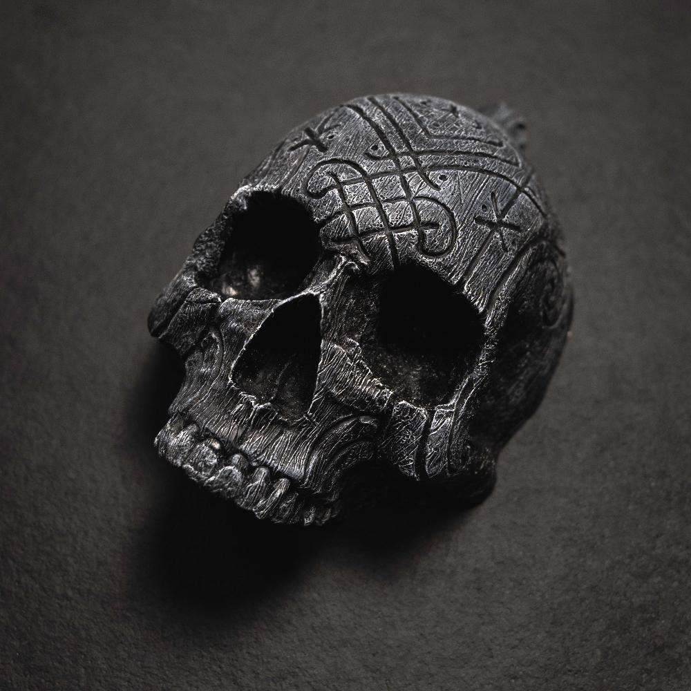 Dark skull pendant with Norse knotwork and runes, Viking-inspired jewelry design