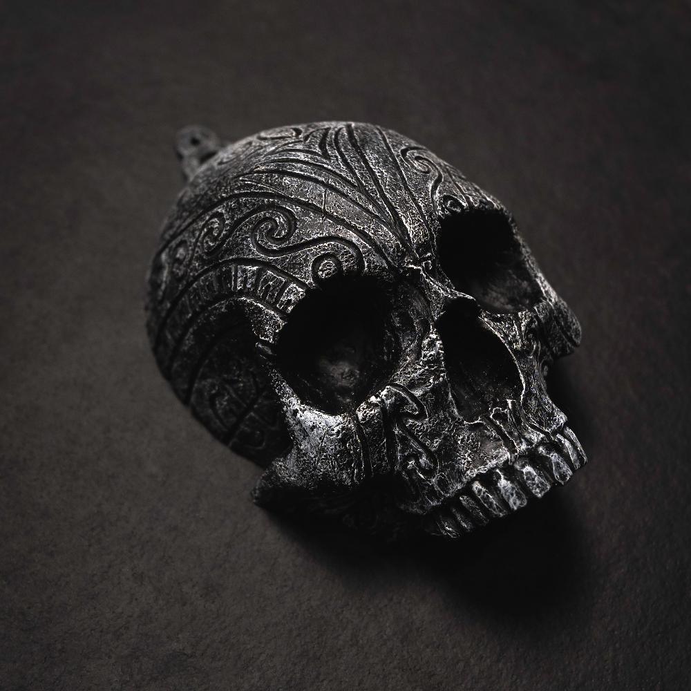 Dark Norse skull pendant with intricate Viking knotwork and runic carvings, inspired by ancient artifacts.