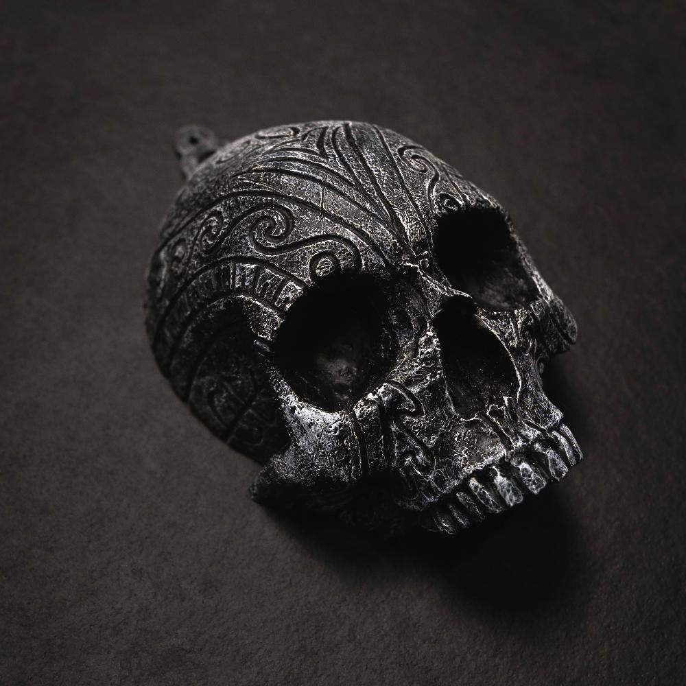 Dark Norse skull pendant with intricate Viking knotwork and runic carvings, inspired by ancient artifacts.