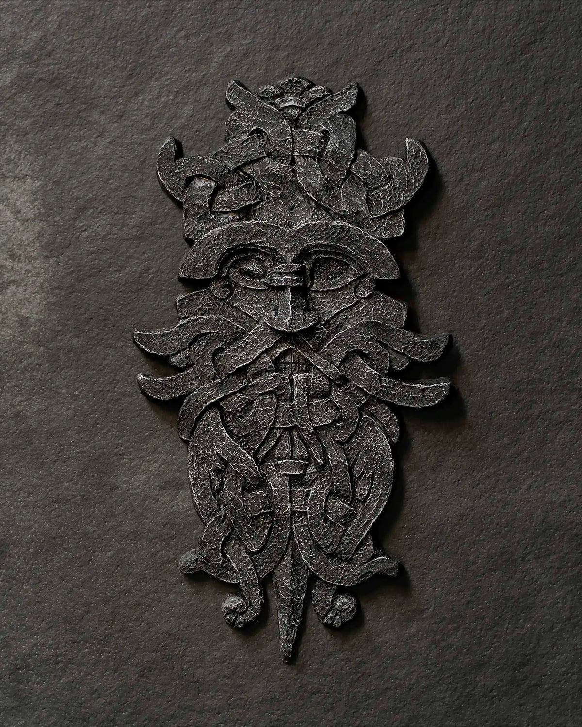 Viking-inspired Norse art resin sculpture with intricate knotwork and mythical face design