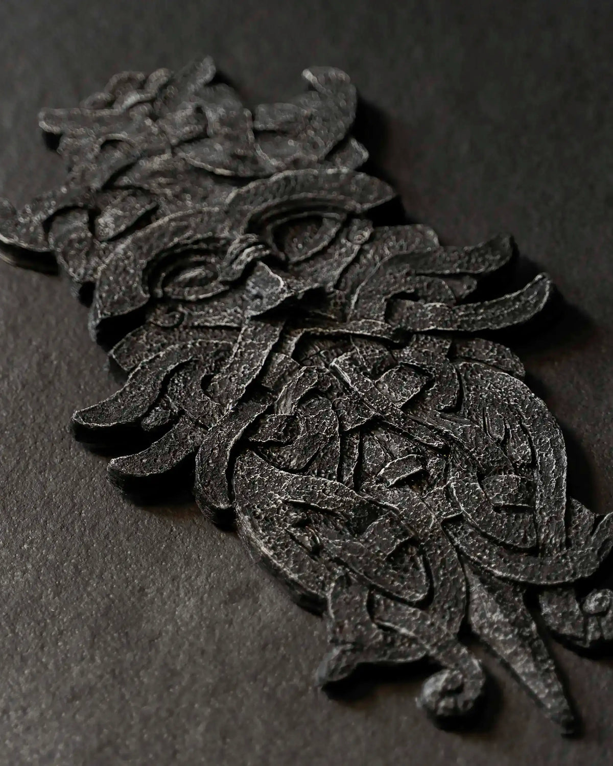 Viking-inspired resin sculpture with intricate Norse knotwork and mythical creature design