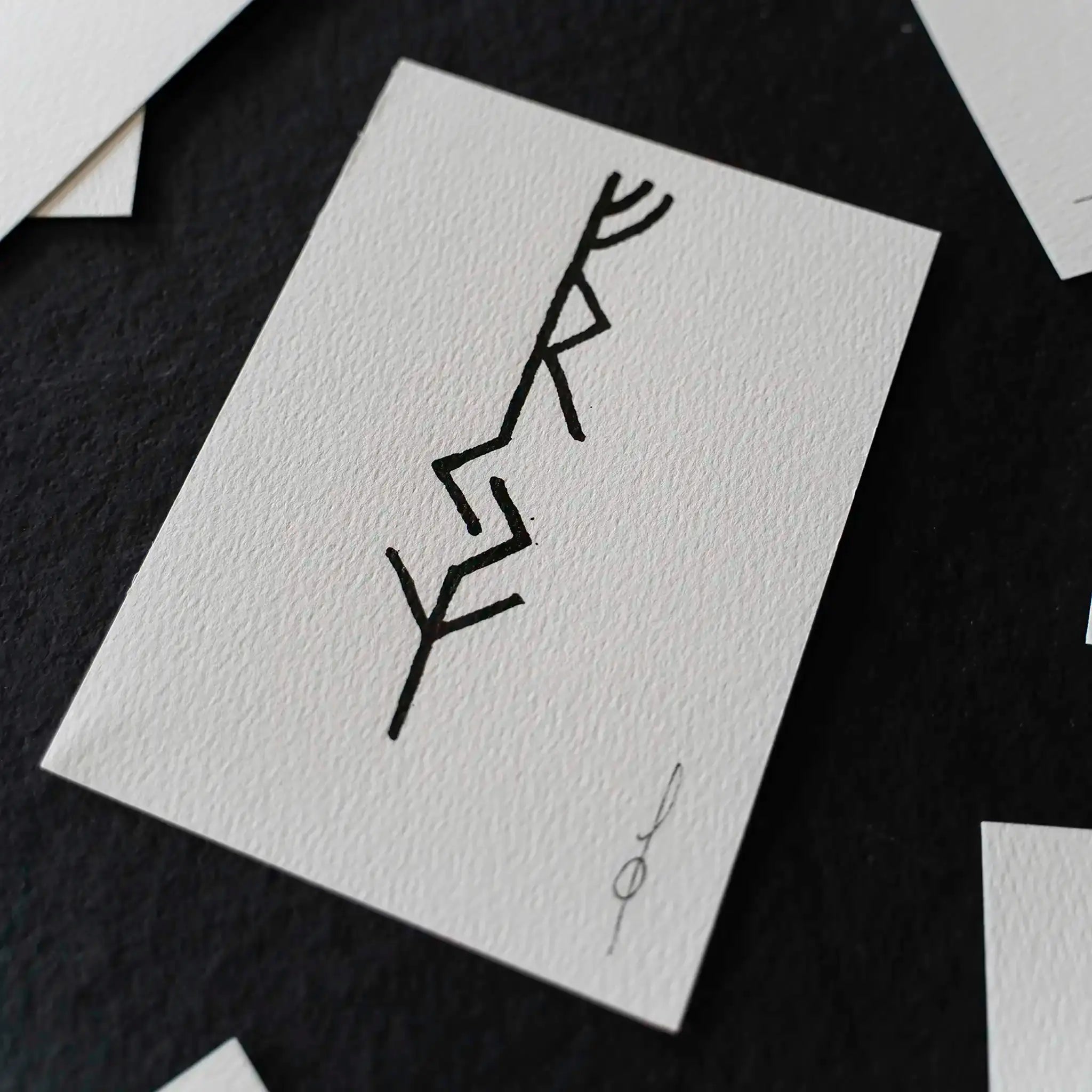 Norse rune design on textured white card, hand-drawn Viking symbol for tattoo or art inspiration