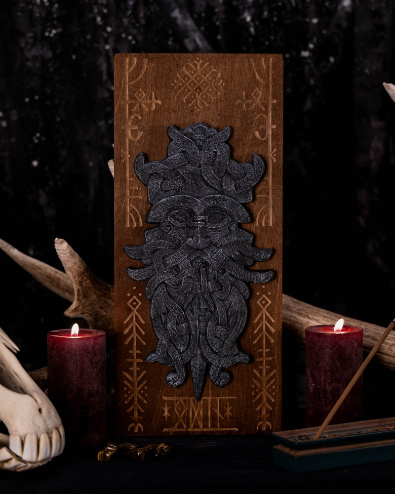 stonelike godmask of odin, put on a engraved wooden background with runes