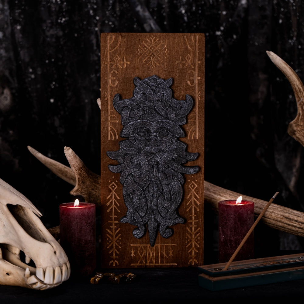 stonelike godmask of odin, put on a engraved wooden background with runes