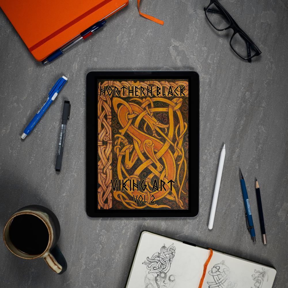Northern Black Viking Art Vol 2 digital book on tablet with sketchbook, pens, and coffee — Norse tattoo designs
