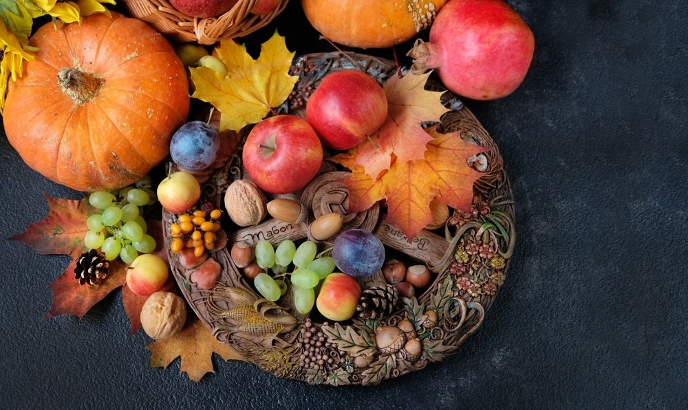 Harvest fruits and autumn leaves on altar