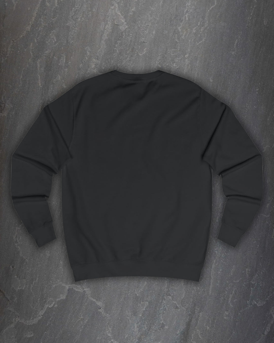 Plain back of the black F*ck Off Bindrune sweatshirt on a dark slate background
