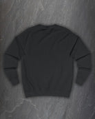 Plain back of the black F*ck Off Bindrune sweatshirt on a dark slate background