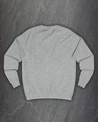 Plain back of the heather grey F*ck Off Bindrune sweatshirt on a dark slate background