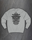 Back of a heather grey Odin Godmask sweatshirt with a large black Norse knotwork Odin mask print on a dark slate background
