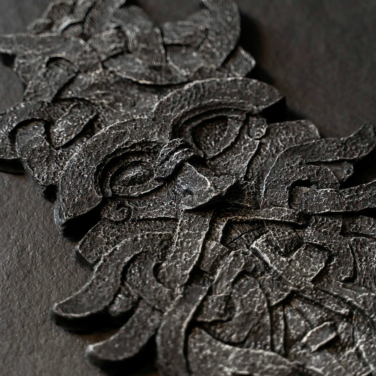 Intricate Norse-inspired resin sculpture with Viking knot patterns and textured finish