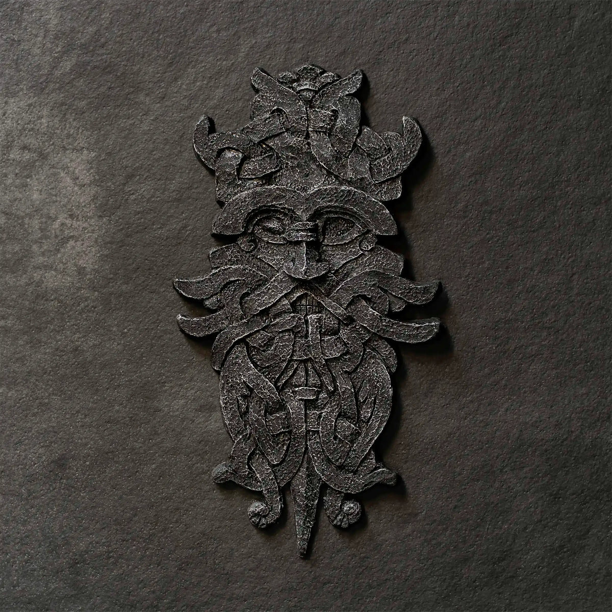 Viking-inspired Norse art resin sculpture with intricate knotwork and mythical face design