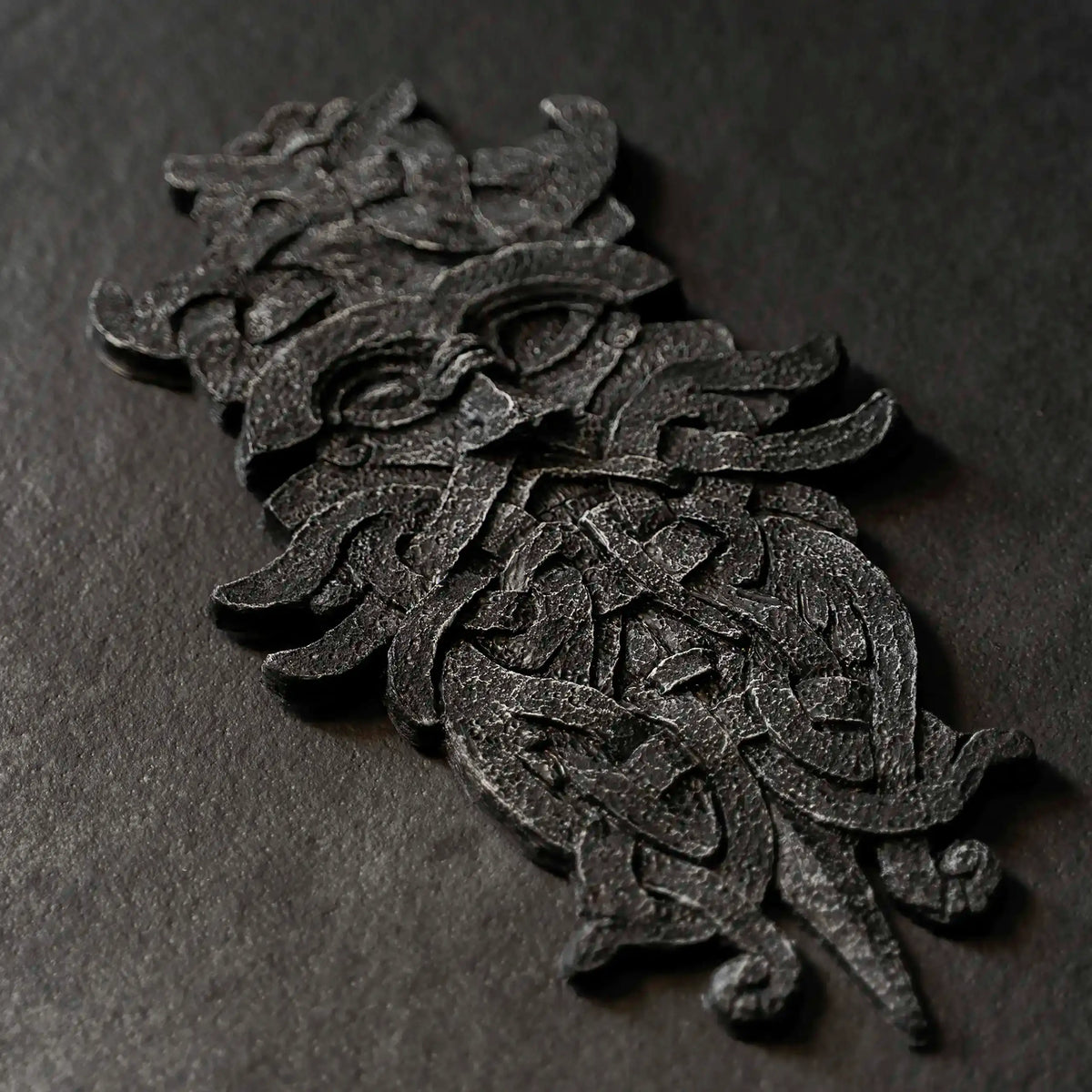 Viking-inspired resin sculpture with intricate Norse knotwork and mythical creature design