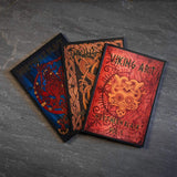 Viking art books with Norse designs, featuring Northern Black Vol 1 and intricate knotwork patterns.