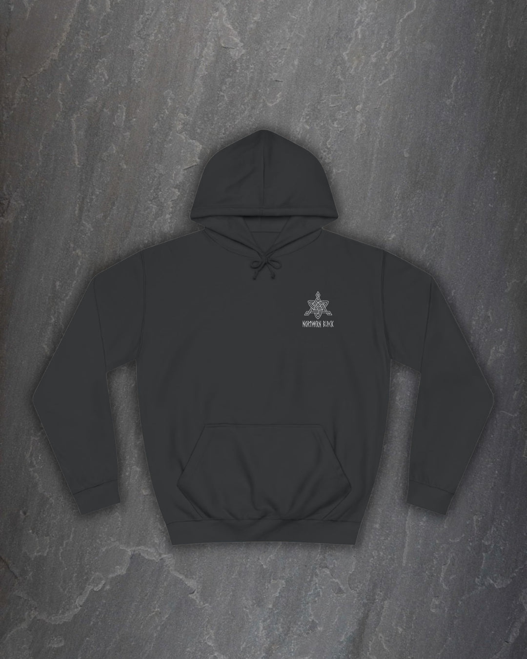 Front of a black Yggdrasil hoodie with a small Northern Black logo on the chest on a dark slate background