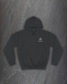 Front of a black Yggdrasil hoodie with a small Northern Black logo on the chest on a dark slate background